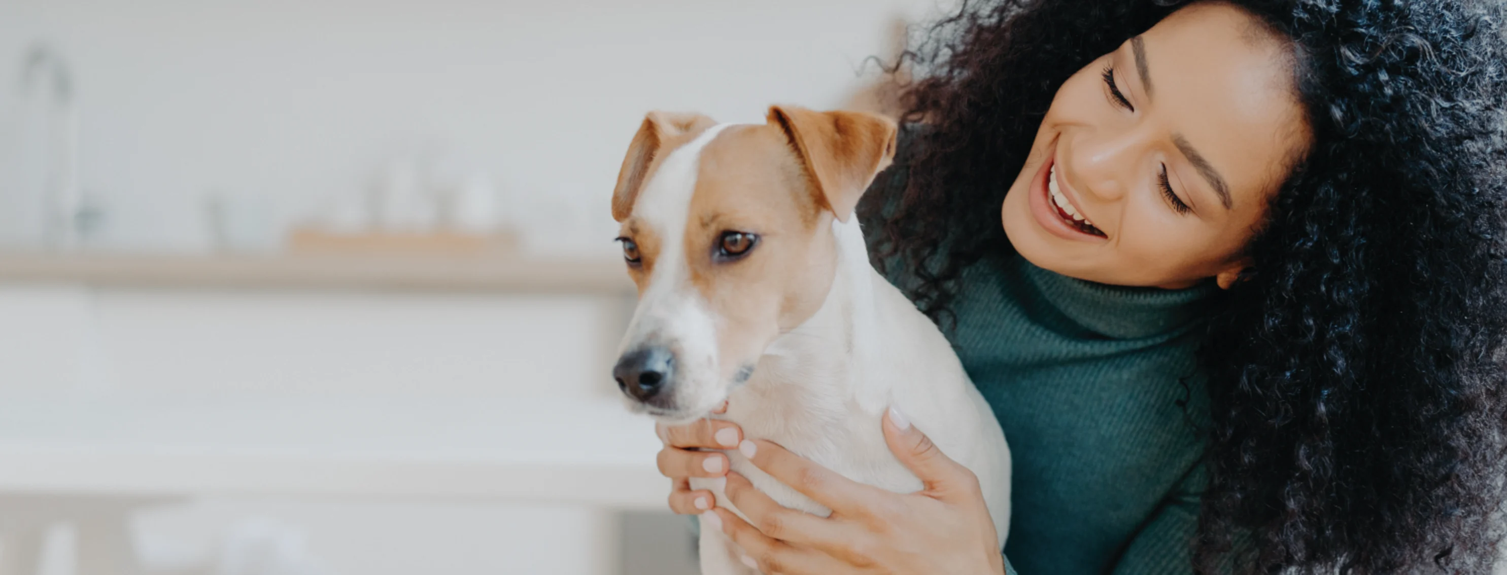Woman looking at dog holding up